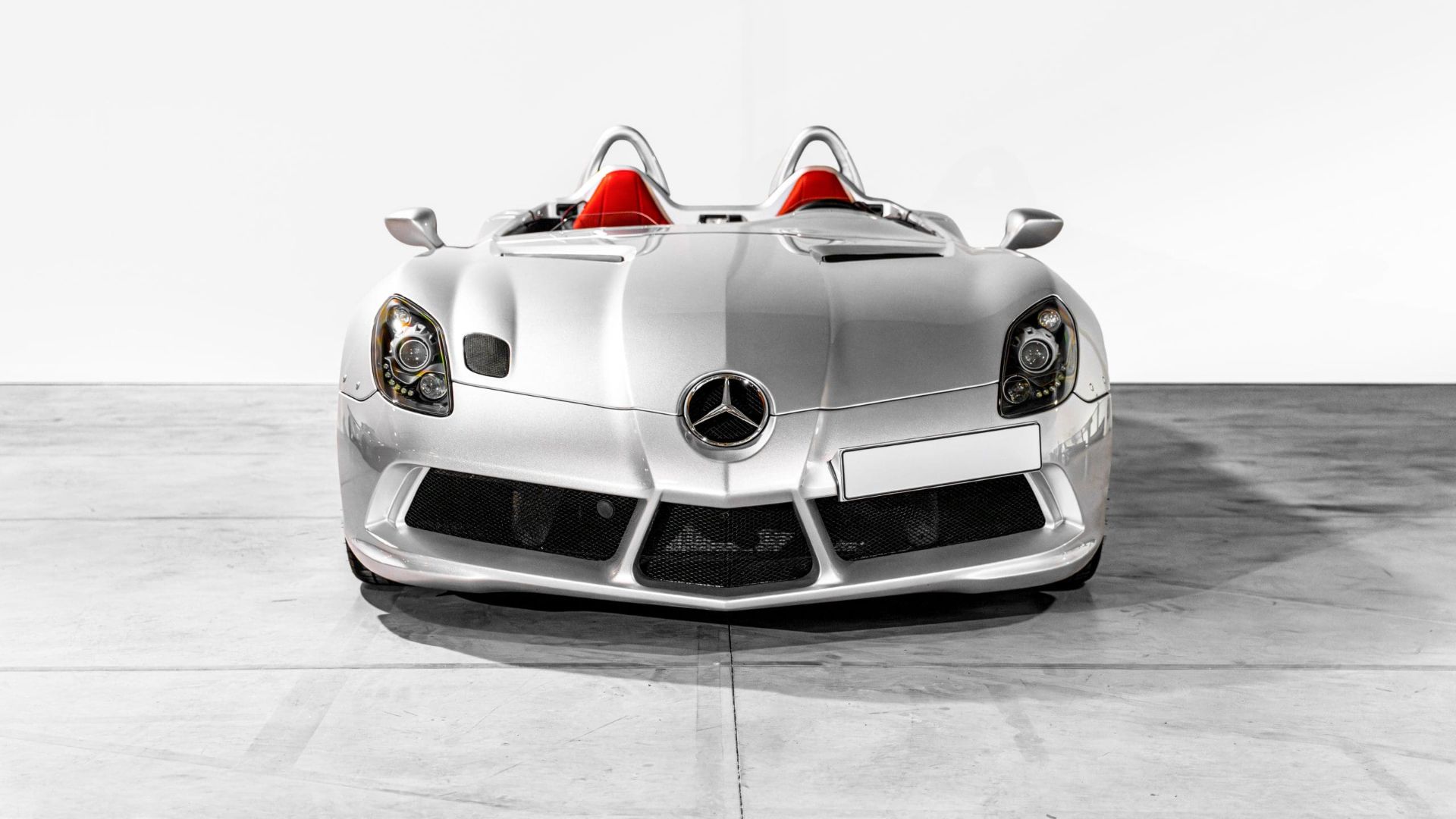 Head-on view of a silver Mercedes-Benz SLR McLaren Stirling Moss with red leather seats