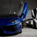 two white and blue Lamborghini vehicles inside garage