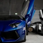 Philadelphia Man Accused of $3.8 Million Exotic Car Title Scheme two white and blue Lamborghini vehicles inside garage