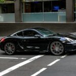 black porsche 911 parked on parking lot during daytime
