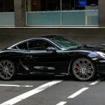 black porsche 911 parked on parking lot during daytime