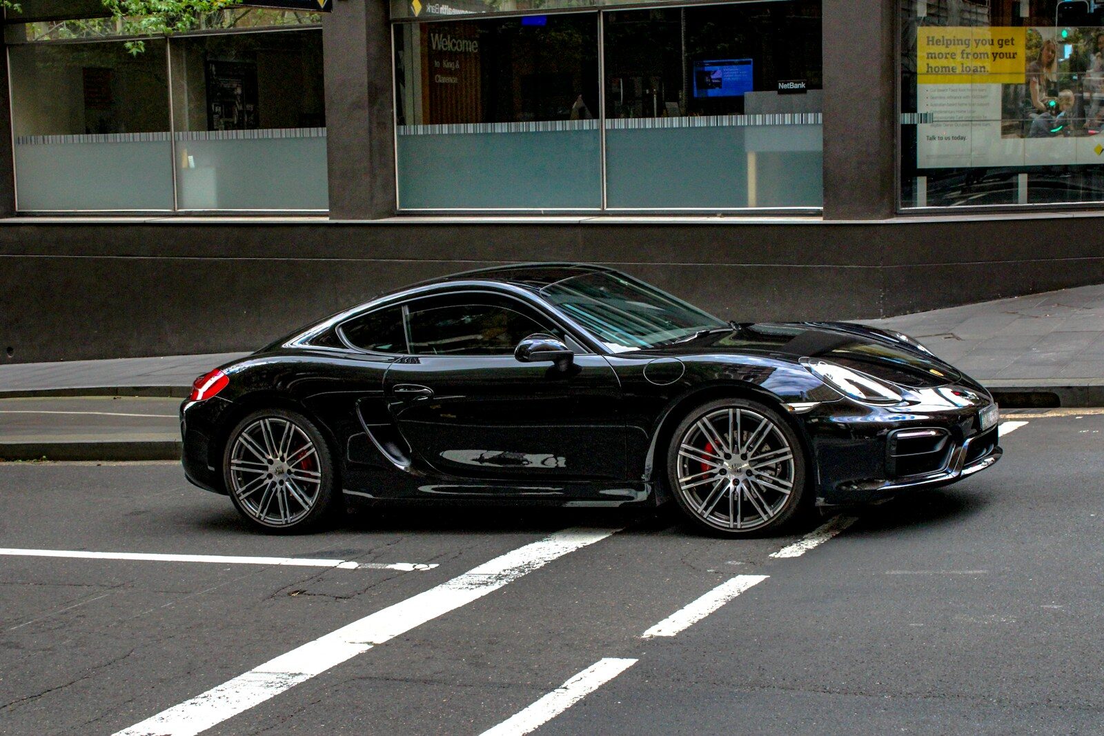 black porsche 911 parked on parking lot during daytime