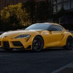a yellow sports car parked in a parking lot