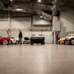 a man standing next to a row of parked cars