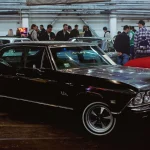 Fort Wayne American Launches Documentation Service for 1968–1974 AMC Vehicles a group of people standing around a car show