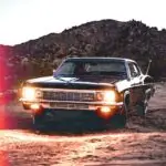 black chevrolet camaro on brown soil