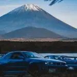 Best JDM Cars to Invest In black chevrolet camaro on road near mountain during daytime