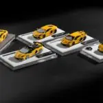 Several yellow toy sports cars arranged on white platforms.