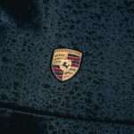 Will the Porsche 997 Appreciate? a close up of a car's emblem on a wet surface