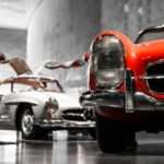 Why Documentation Is Becoming More Important Than Restoration Quality two vintage cars beside gray concrete wall