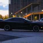 A black sports car parked on the side of the road