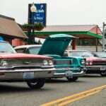 A row of classic cars parked on the side of the road