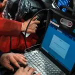 Best OBD2 Scanners and Diagnostic Tools for Classic and Modern Collector Cars A man sitting in a car using a laptop computer
