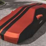 Best Car Covers for Classic & Collector Cars: Indoor and Outdoor Picks for 2026 red ferrari car on gray concrete pavement