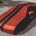 red ferrari car on gray concrete pavement