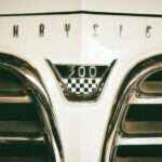 Close-up of a 1955 Chrysler 300 hood badge and grille, the model at the center of a disputed convertible