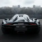 a black sports car driving down a street