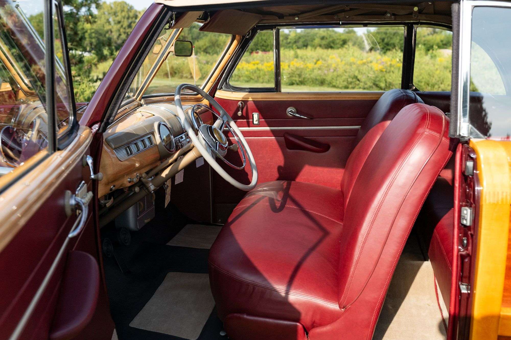 Restored red leather interior of the 1947 Ford Super Deluxe Sportsman