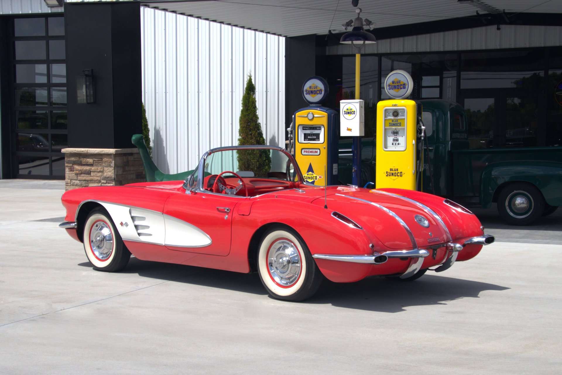 1958 Chevrolet Corvette formerly owned by George Strait, rear three-quarter view by gas pumps, for sale at GAA Classic Cars
