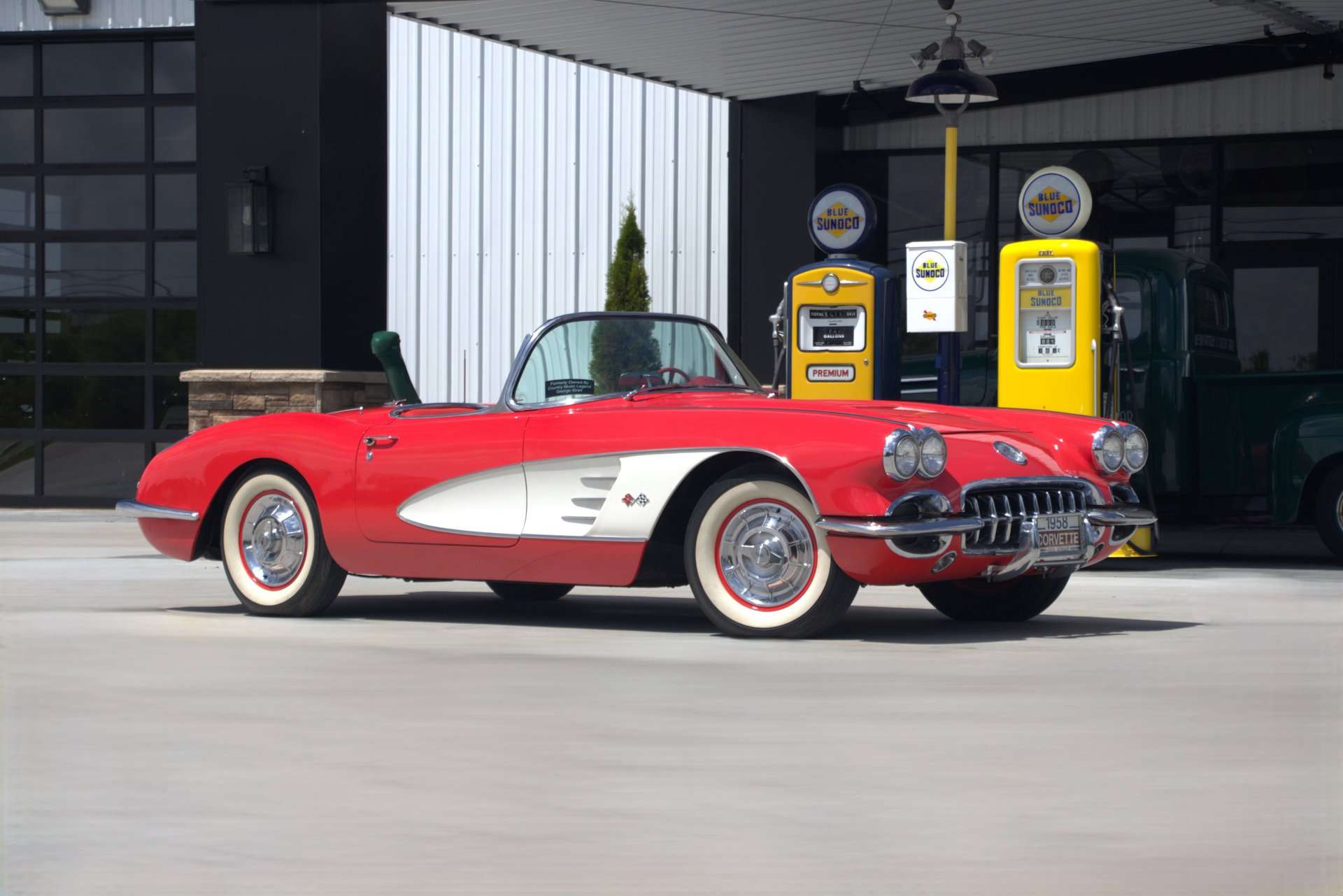 1958 Chevrolet Corvette formerly owned by George Strait, driver side profile with gas pumps, for sale at GAA Classic Cars