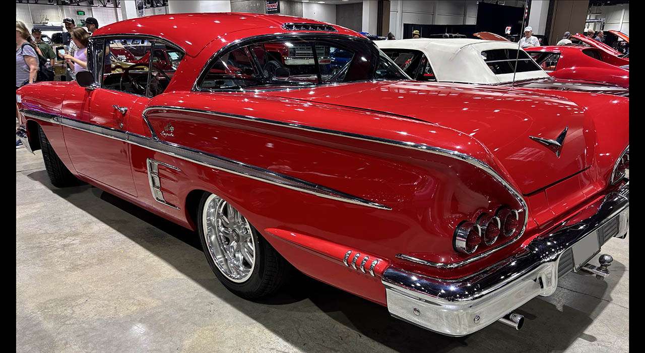 Rear three-quarter view of the 1958 Chevrolet Impala showing its sculpted quarter panels and triple taillights