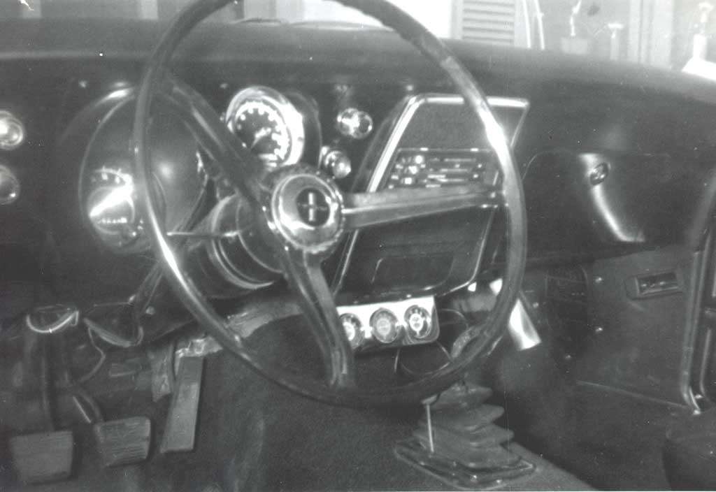 Black-and-white photo of a 1967 Chevrolet Camaro Z/28 dashboard and shifter