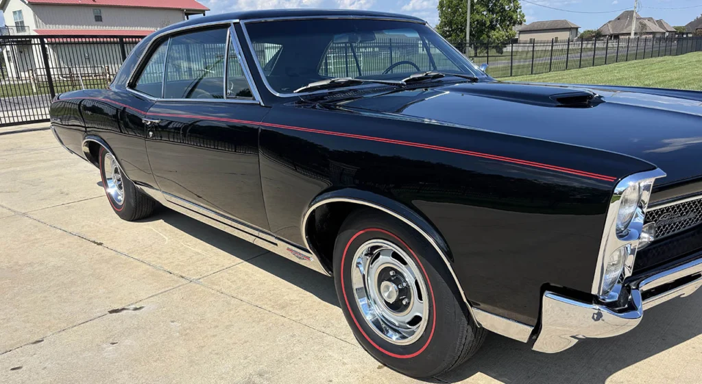 Side profile of the black 1967 Pontiac GTO with redline tires and Rally wheels