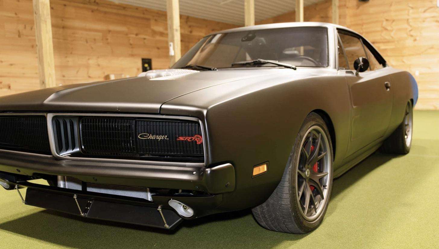 1969 Charger grille with Charger SRT badging above a modern front splitter on the Bay One Customs Hellcat restomod