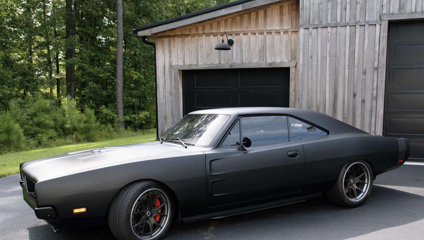 1969 Dodge Charger Hellcat restomod in satin black, side profile showing widened track and modern forged wheels