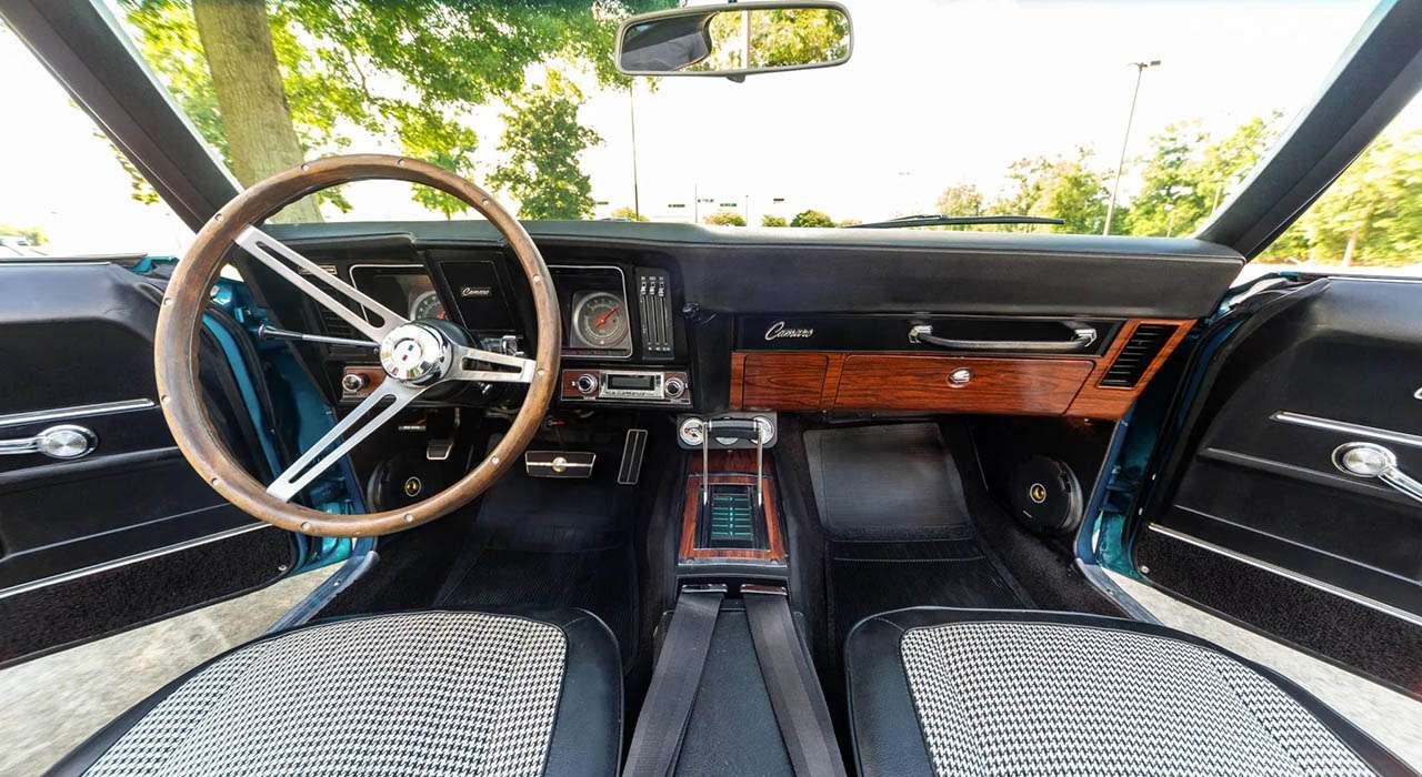 1969 Camaro dashboard with wood-rimmed steering wheel and AutoMeter gauges