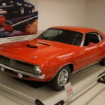 1970 Plymouth Hemi 'Cuda in orange on museum display, front three-quarter view