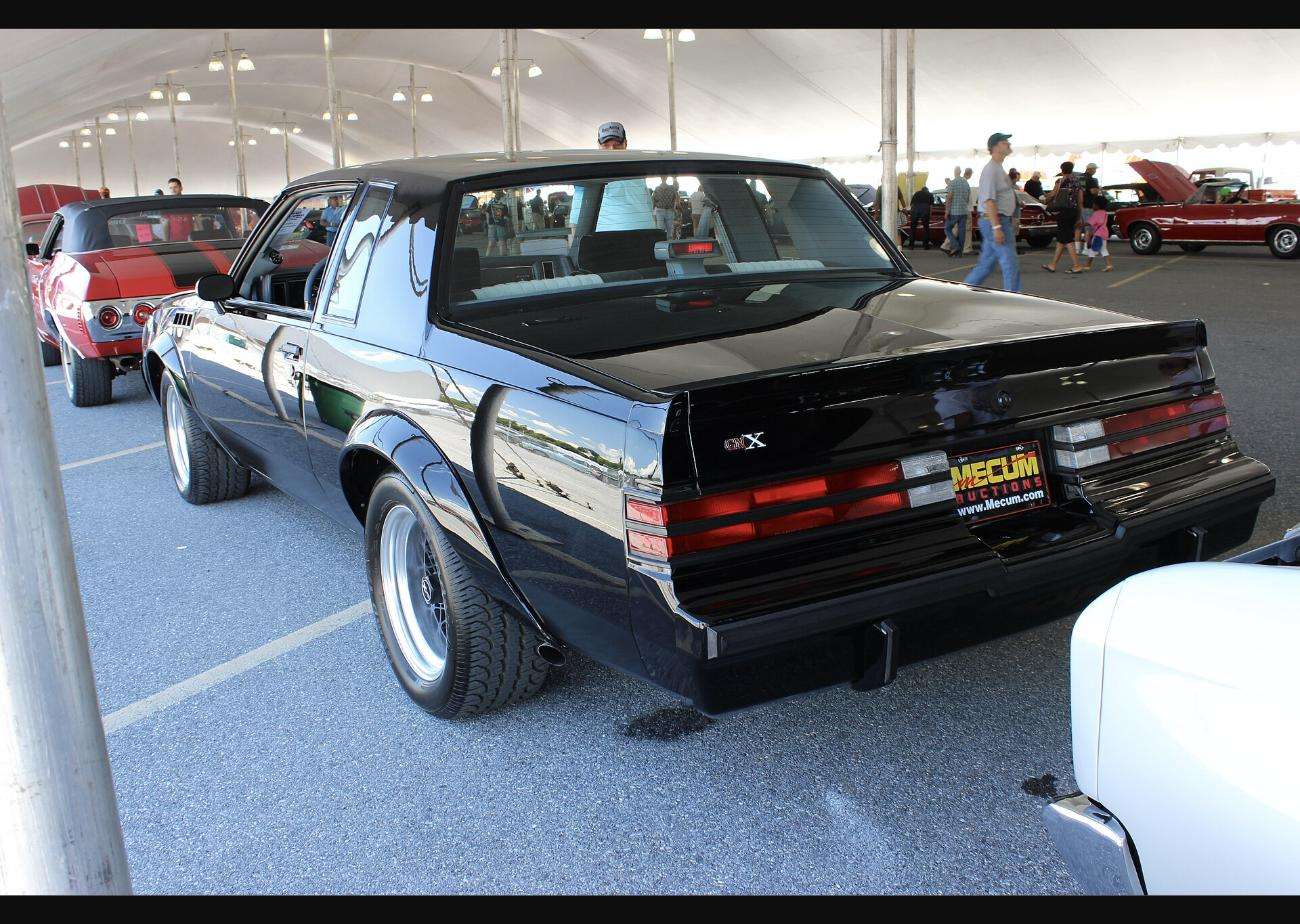 1987 Buick GNX rear three-quarter view showing the rear spoiler, GNX decklid badge and flared rear quarters