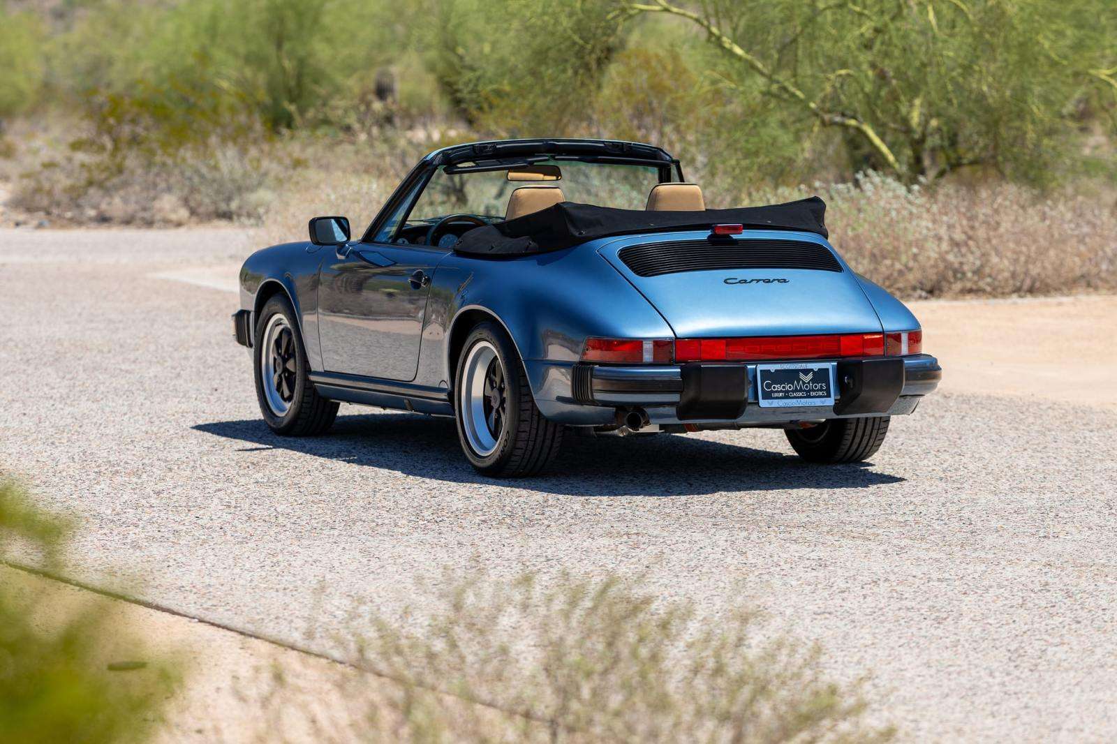 Rear three-quarter view of the Baltic Blue 1989 Porsche 911 Carrera Cabriolet