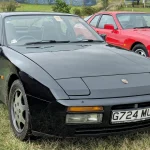 Black 1990 Porsche 944 S2 coupe, front three-quarter view, the transaxle model underpinning the Carpoint GT-K44