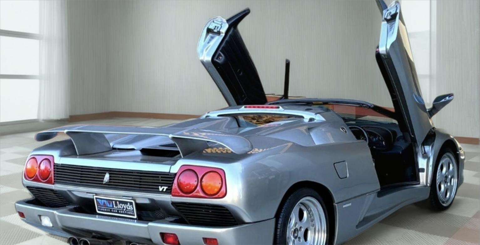1998 Lamborghini Diablo VT Roadster from the rear three-quarter with both doors raised and the targa panel removed