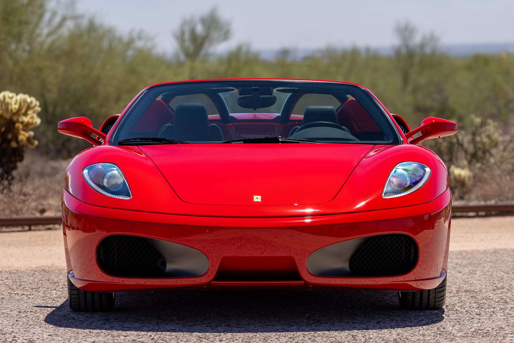 Front view of 2006 Ferrari F430 Spider showing xenon headlights and oval intakes