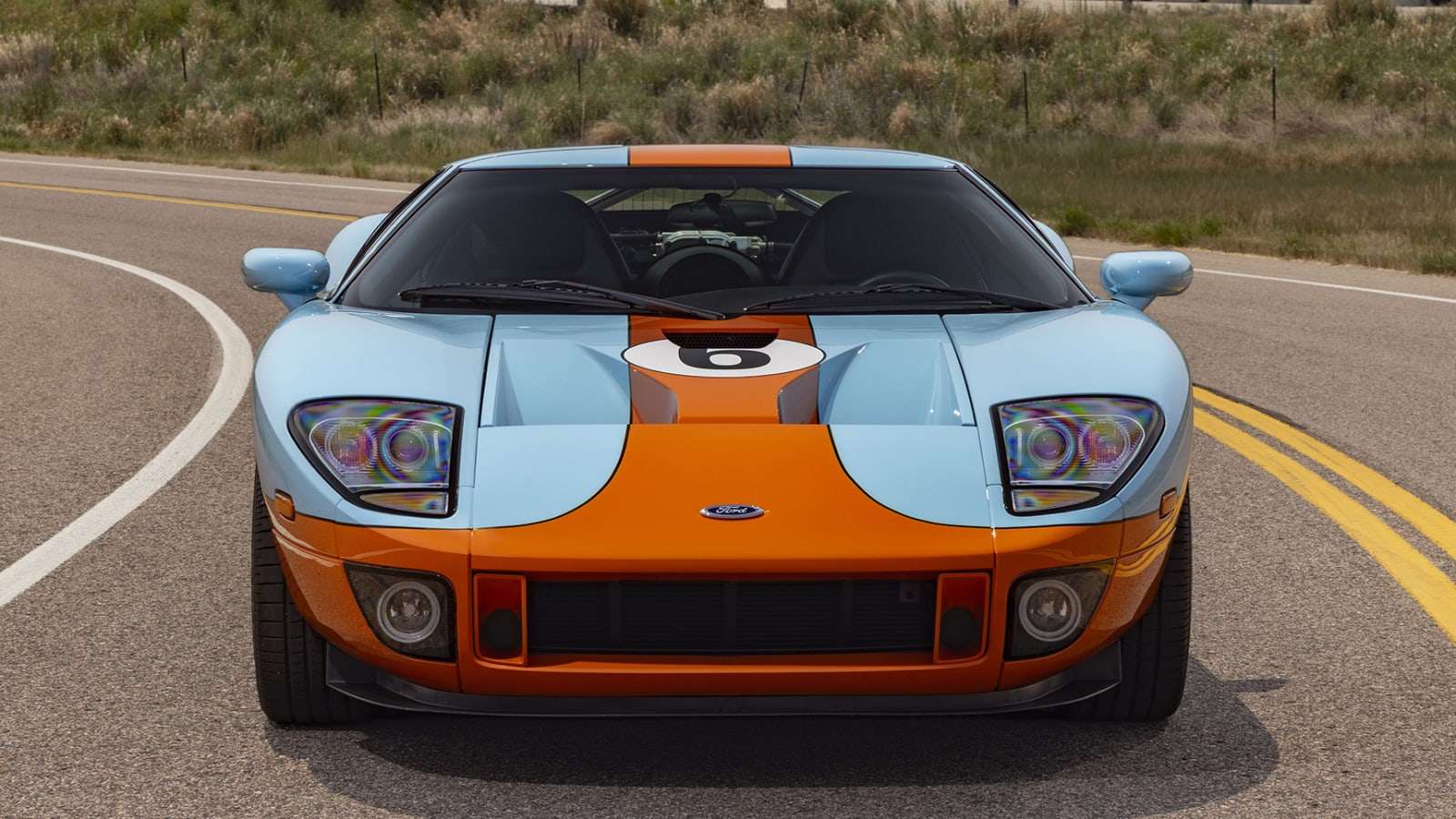 Head-on view of the Gulf livery Ford GT with orange center stripe and HID headlights