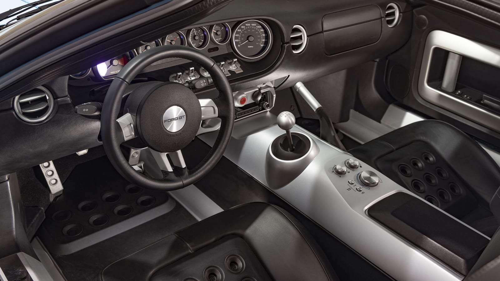 Interior of the 2006 Ford GT with GT40-style analog gauges and six-speed manual shifter
