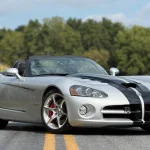 The Last Open Viper Has Just 9,000 Miles, and That's the Least Interesting Thing About It 2010 Dodge Viper SRT-10 Roadster in Bright Silver Metallic with black stripes, front three-quarter view