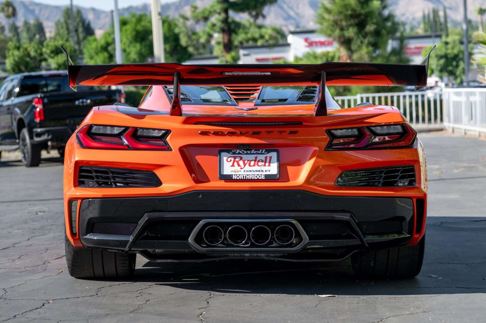 Rear view of the Sebring Orange 2027 Corvette ZR1X showing the Carbon Fiber Aero Package rear wing