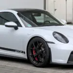 2027 Porsche 911 GT3: The Naturally Aspirated Flat-Six Enters Its Final Act White Porsche 911 GT3 (992) coupe with swan-neck rear wing, front three-quarter view