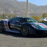 A standard Porsche 918 Spyder Weissach in Martini livery, shown with its two-piece removable roof panels in place — the configuration every catalog 918 left the factory with, unlike the fixed-roof coupe.
