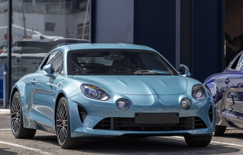Light blue Alpine A110 GT parked outdoors, a less likely collector car than the limited editions
