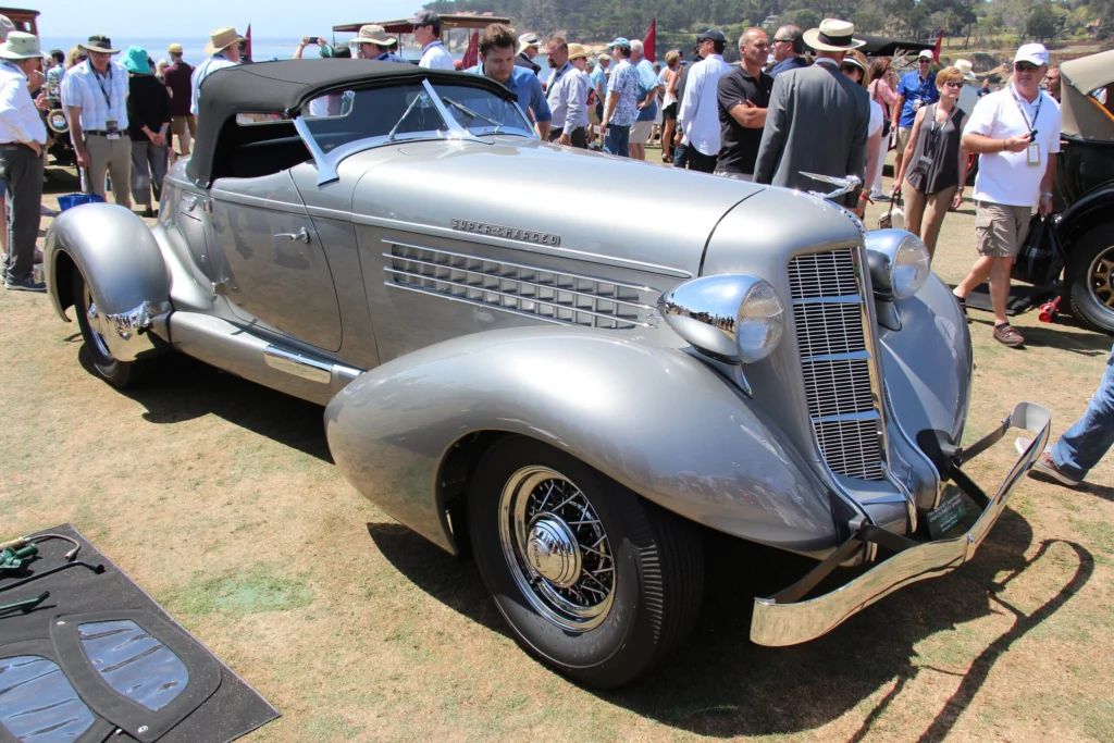 Silver 1935 Auburn 851 Supercharged Speedster with top raised on a concours lawn