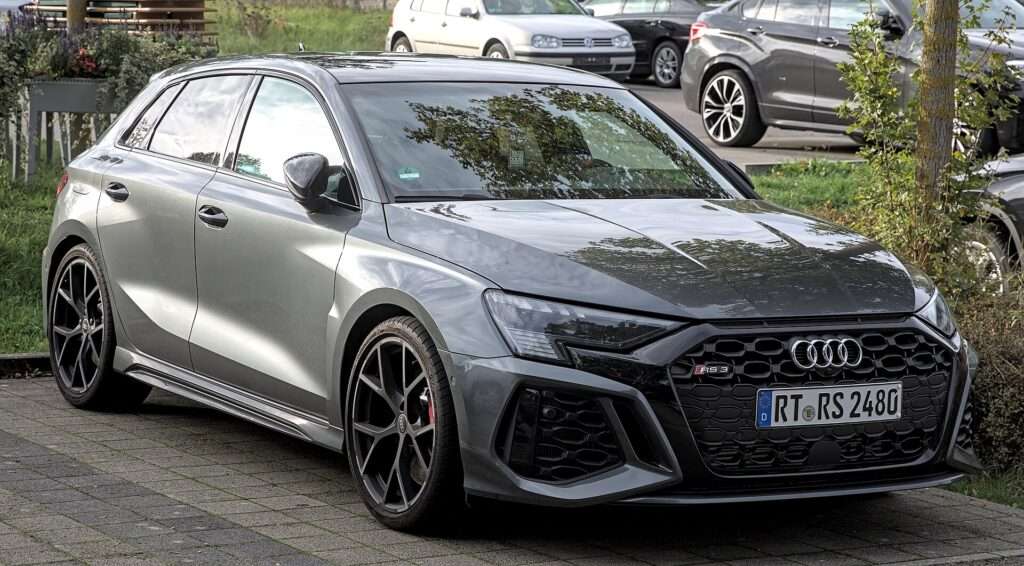 Current-generation Audi RS 3 Sportback in gray, front three-quarter view