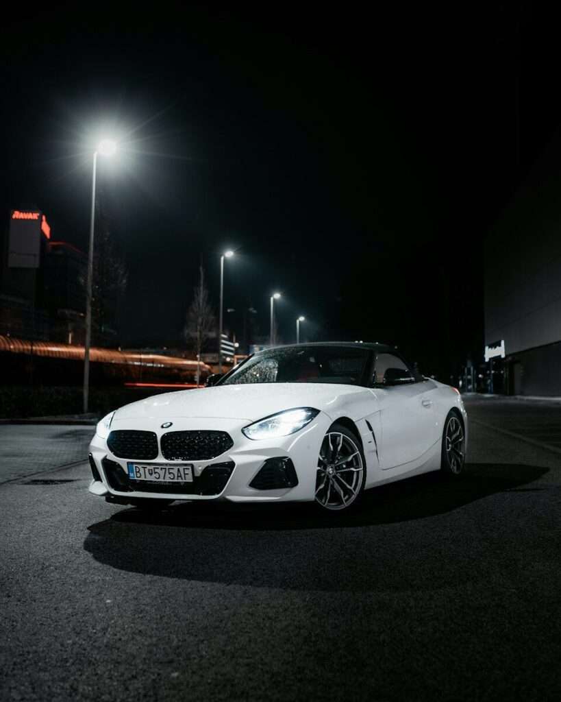 White BMW Z4 G29 roadster photographed at night under street lights