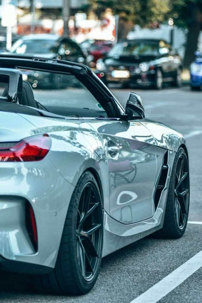 Rear three-quarter view of a silver BMW Z4 roadster with the soft top folded down