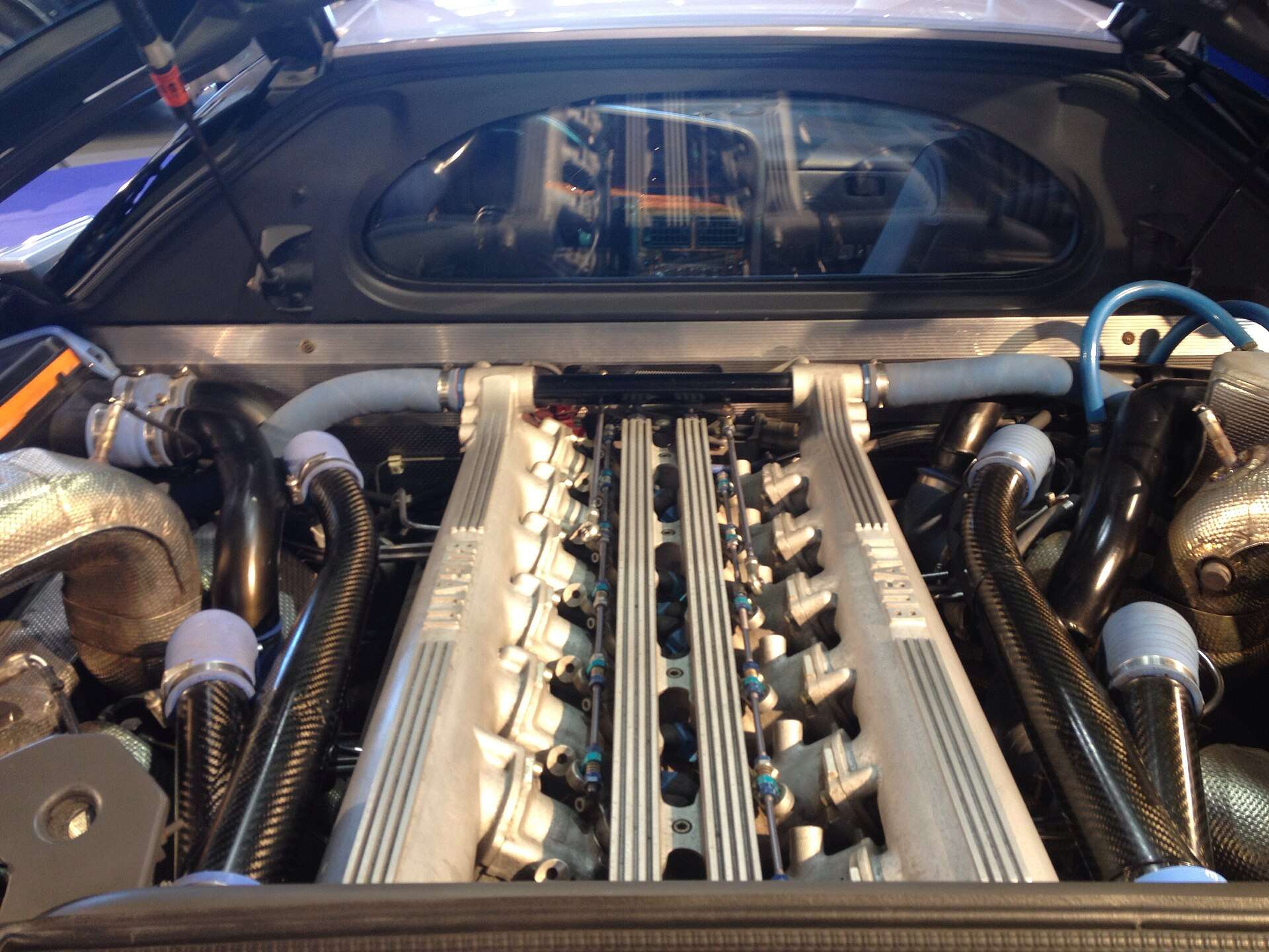 The 3.5-litre quad-turbocharged 60-valve V12 engine of a Bugatti EB110 seen through the engine cover