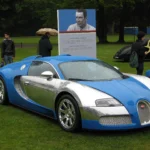 Collector Car Market Brief: A One-of-Three Veyron Soars in Zurich While the Hypercars Stall Blue and silver Bugatti Veyron 16.4 Centenaire dedicated to Jean-Pierre Wimille, displayed on a lawn with a Wimille portrait board