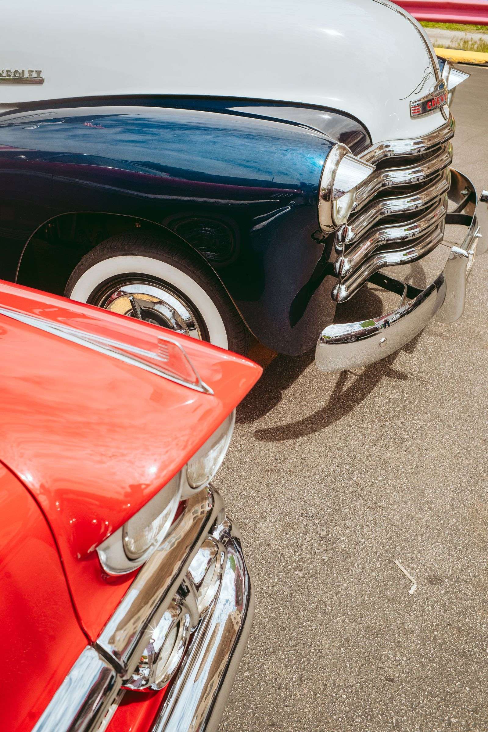 Chrome trim and bodywork detail on a red classic car